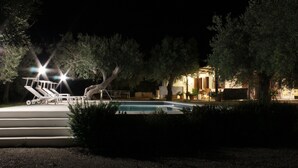 A nighttime outdoor pool area with lounge chairs and a staircase leading to a building. - IL VILLINO --- SWIMMING POOL NOT SHARED AND PRIVATE BEACH --- (Cefalù)