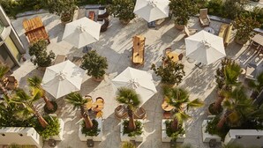 An aerial view of a courtyard with outdoor seating, umbrellas, and potted plants. - Santa Monica Proper Hotel, a Member of Design Hotels (Santa Monica)