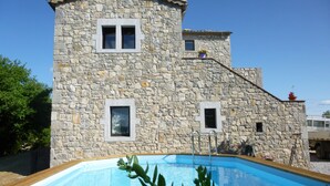 A stone building with a swimming pool in front. - Fully air-conditioned stone villa with panoramic views and private pool. (Labeaume)