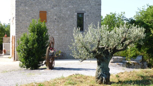 A stone building with a tiled roof, a small door, and a window. - Fully air-conditioned stone villa with panoramic views and private pool. (Labeaume)