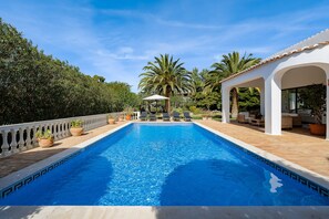 A heated pool, pool loungers