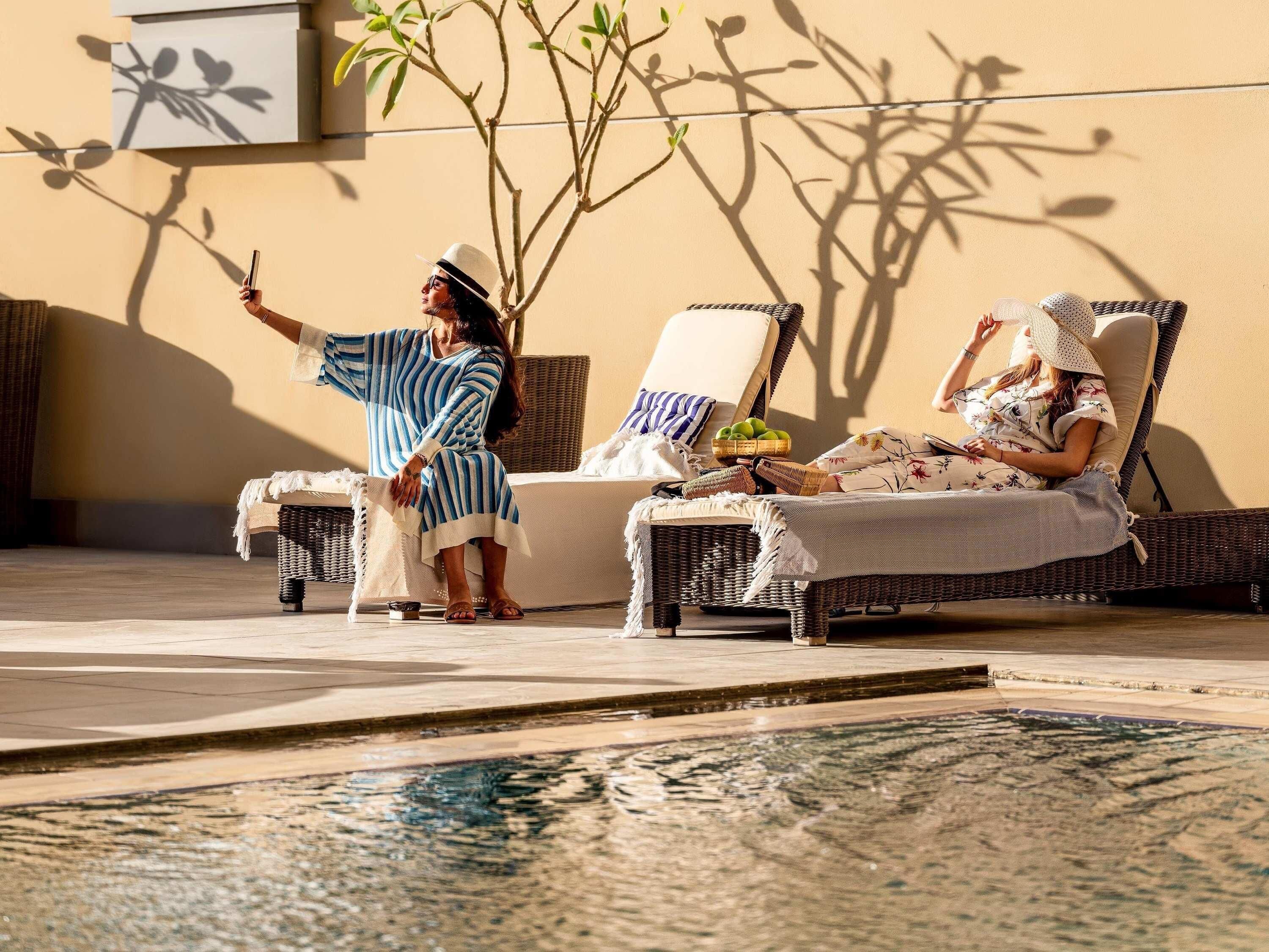 Outdoor pool, open 6:30 AM to 7:00 PM, pool umbrellas
