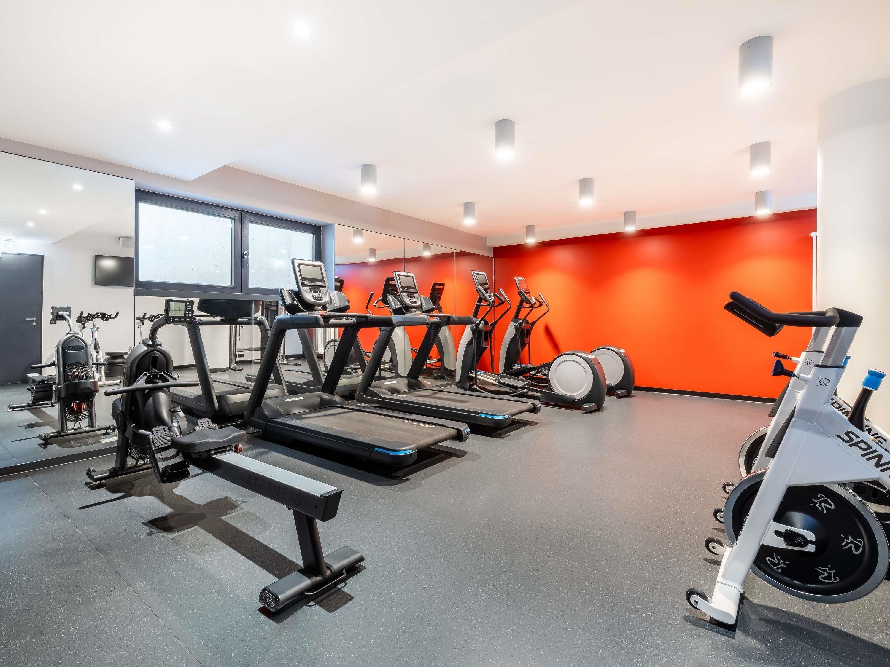 A gym with treadmills, stationary bikes, and weight machines.