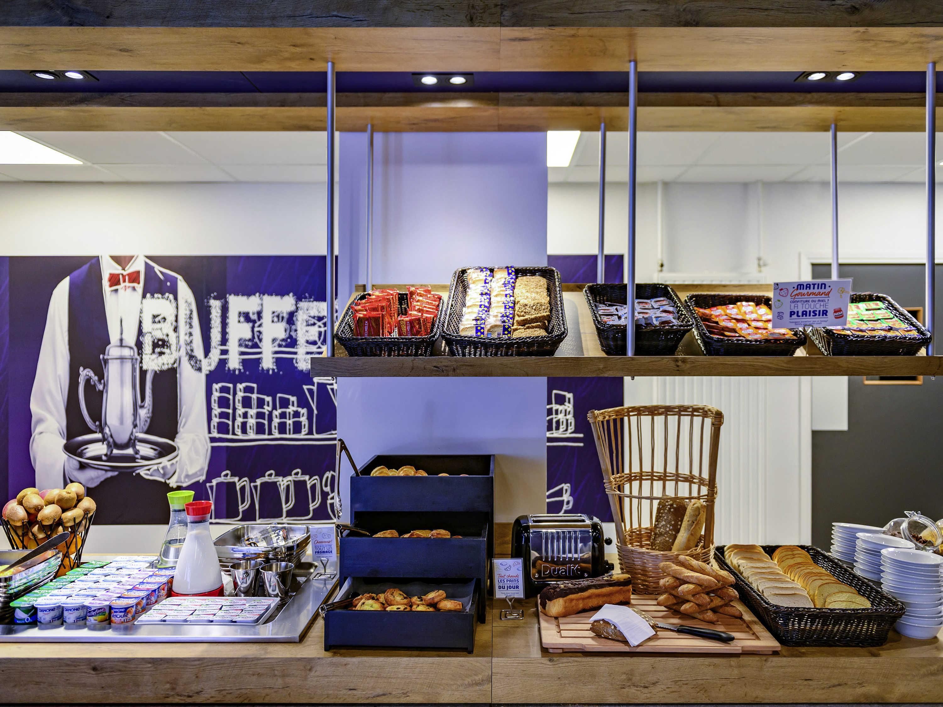Un buffet de petit-déjeuner proposant une variété d’aliments et un coin café.
