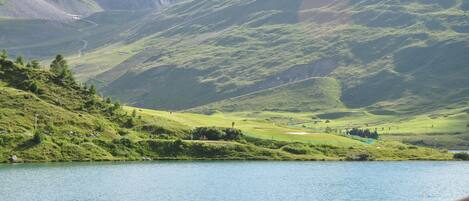 A lake with boats and a mountainous landscape in the background.