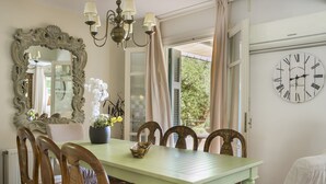 A dining area with a green table, wooden chairs, a large mirror, and a wall clock. - 'Phivos Villa'Elegant Villa With Dramatic Mountain & Sea Views, Totally Equipped (Kefalonia)