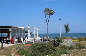 A seaside restaurant with outdoor seating, a clear view of the sea, and a date stamp of 05.18.2011.