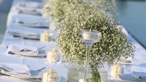 A table set with white linens, clear glassware, and small white flowers. - Bay View Villa Cyprus, Luxury at its finest!! (Protaras)
