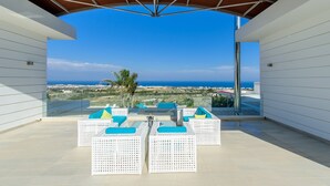 A terrace with white wicker furniture and a clear view of the sea and landscape. - Bay View Villa Cyprus, Luxury at its finest!! (Protaras)