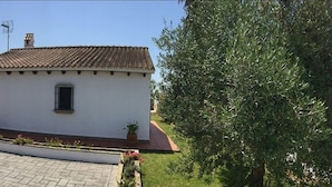 A small, single-story building with a tiled roof and a small window.