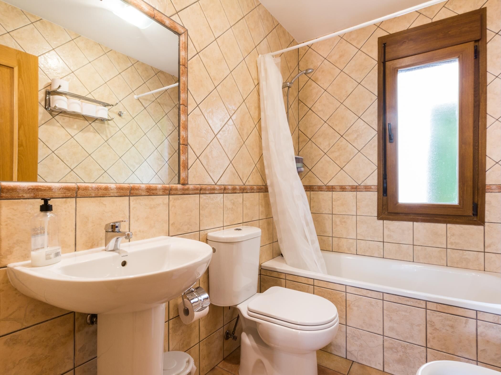 A bathroom with a sink, toilet, and bathtub.