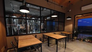 A restaurant with large windows, wooden tables, and chairs. - Villa with pool in Tuscany, close to San Gimignano and Volterra  (Villamagna frazione di Volterra)
