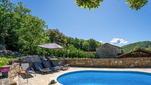 A pool with stone tiles, lounge chairs, and a stone building in the background. - Beautiful  villa for 7 guests with hot tub, private pool, WIFI, A/C, TV and pets allowed (Hum)