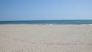 Enjoy a serene beach experience with gentle waves and endless ocean views.