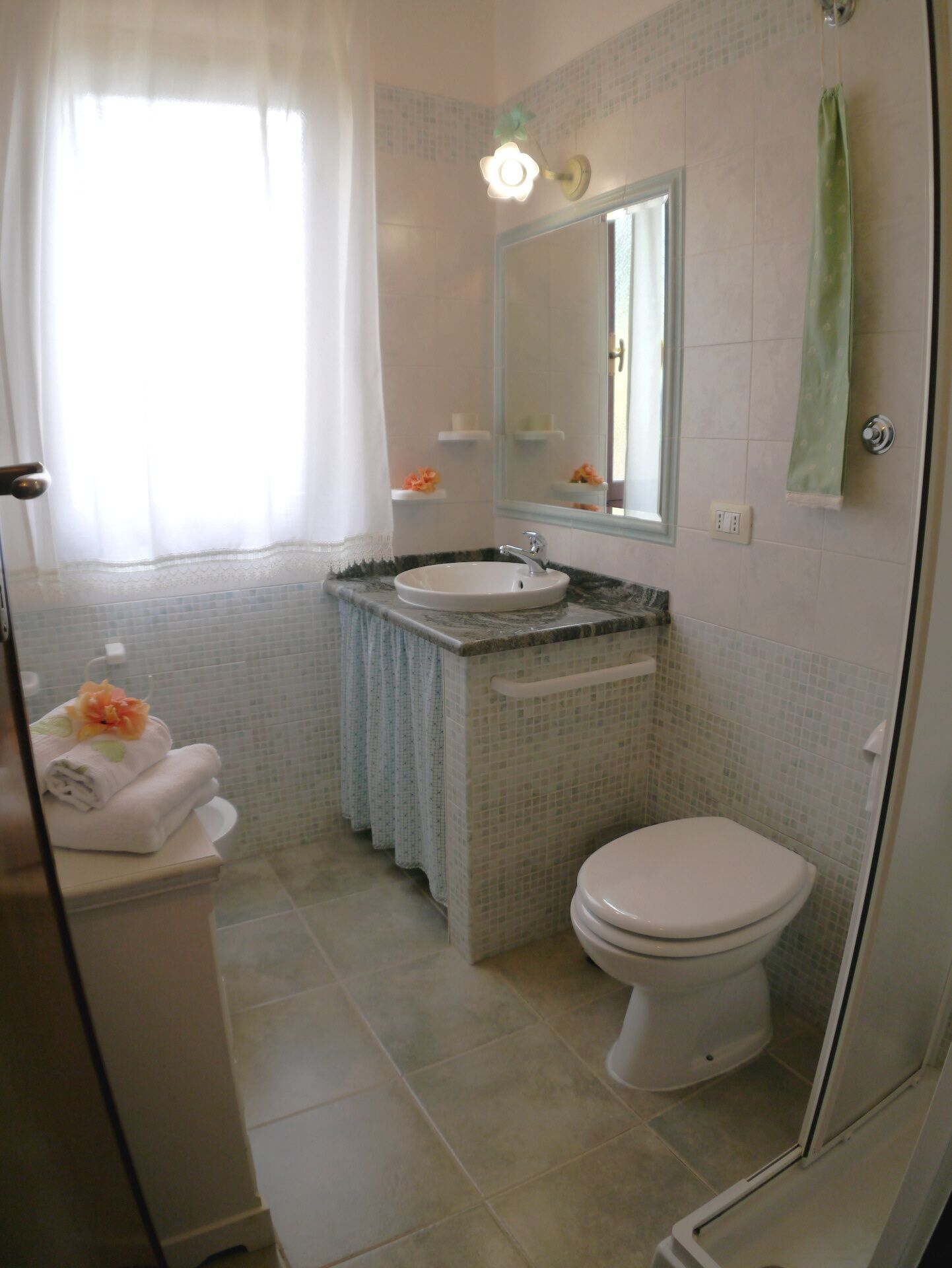 A bathroom with a sink, toilet, and shower.