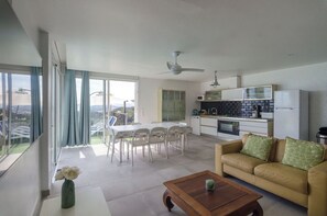 Enjoy meals in the spacious dining area with a table and chairs, and relax on the sofa while taking in the view from the large window.