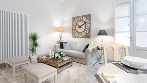 A modern living room with a sofa, coffee table, and lamps.