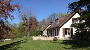 A two-story house with a sloped roof, a covered patio, and a well-maintained lawn. - Saint Didier Au Mont D Or: House with character (Saint Didier au Mont d'Or)
