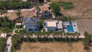 Stunning home with a pool and beautifully manicured lawn.