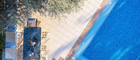 A heated pool, sun loungers