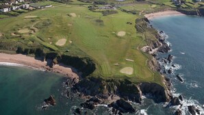 An aerial view of a coastal golf course with bunkers, fairways, and a beach area. - House With Sea Views And Sunny Aspect (Thurlestone)