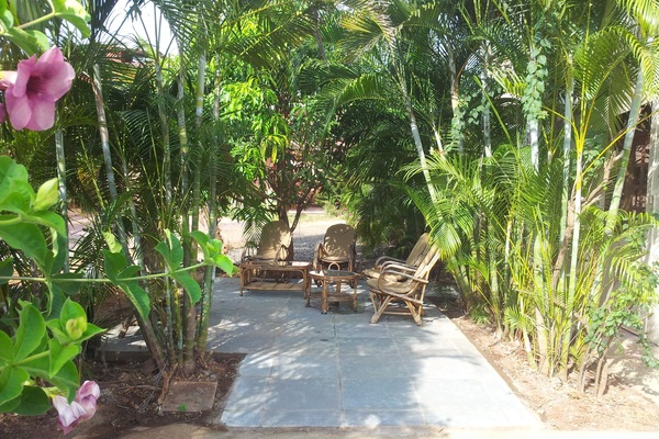 Large Shaded Private Patio Area with Cane Furniture