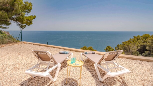 Two lounge chairs with a small table and drinks, overlooking a coastal view. - Mirador, A Luxury villa rental - cliff top retreat with breathtaking views      (Xàbia)