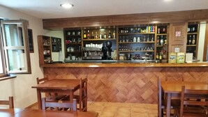 A restaurant with wooden furniture and a herringbone tile floor. - The Caleyon, village house with breakfast. Rooms with private bathroom. (Bulnes de Cabrales)