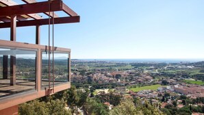 A high-rise building with a glass balcony overlooking a cityscape. - Wonderful private villa with private pool, WIFI, TV, terrace, pets allowed and panoramic view (Calonge)
