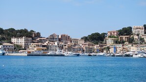 A coastal town with a marina, featuring a variety of buildings, including residential and commercial structures. - Modern townhouse with fantastic views of the Port of Sóller. (Port de Sóller)