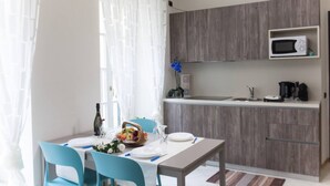 A modern kitchen with a microwave, sink, and wooden cabinets.