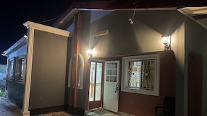 A two-story building with a tiled entrance area and a visible door. - A 2018 built, two bedroom, bungalow for short or long term stay (SerreKunda)