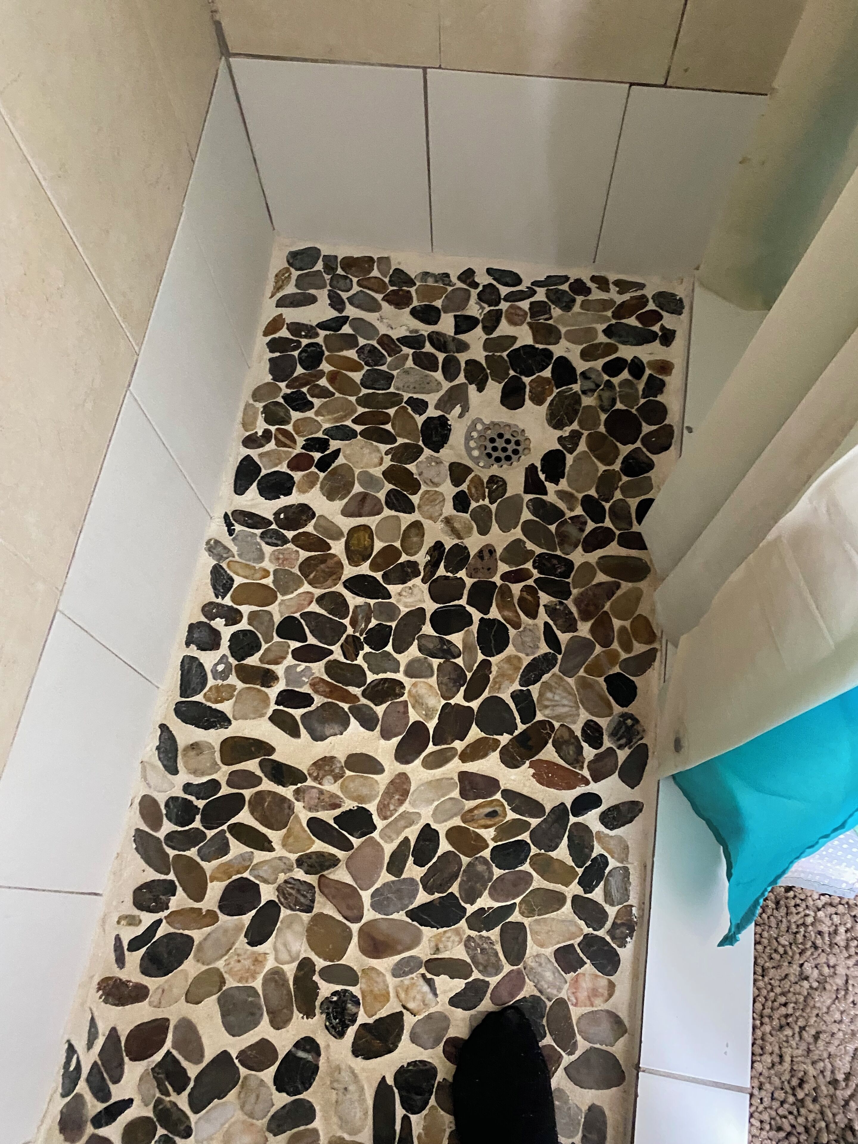 A tiled floor with a pebble mosaic pattern.