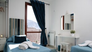 A bedroom with two beds, a desk, a mirror, and a view of the mountains. - Lovely house close to the lake with panoramic lake and mountain views (Acquaseria, San Siro)