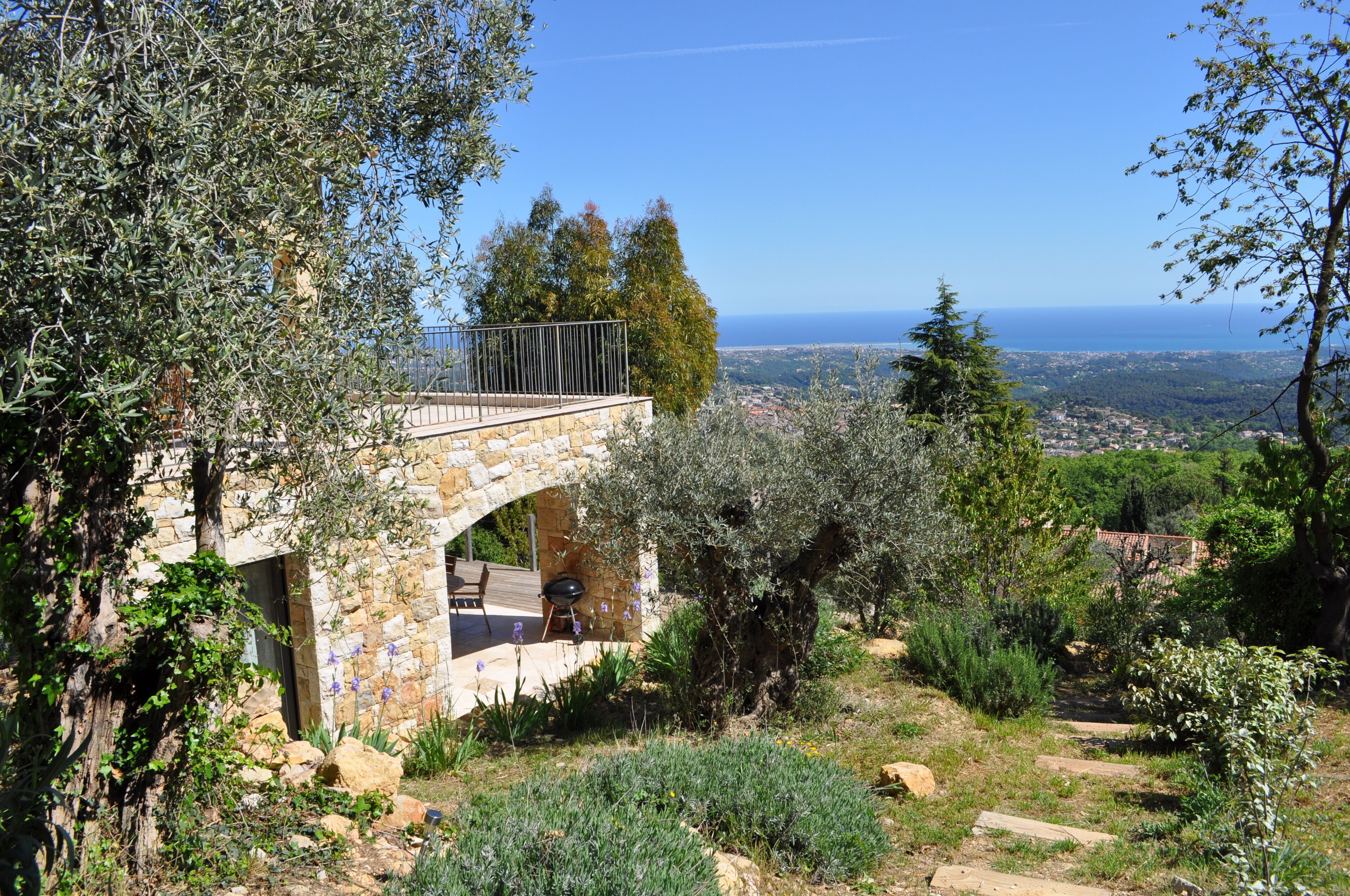 A stone building with a balcony overlooking a scenic landscape.