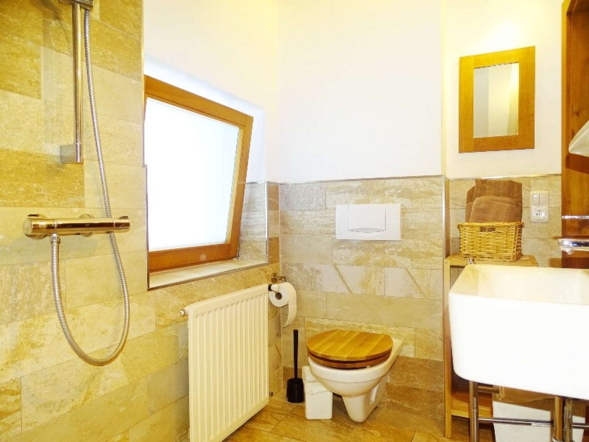 A bathroom with a shower, toilet, and sink.