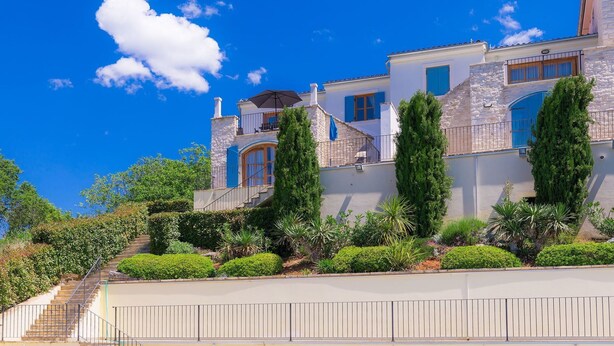A two-story house with a stone facade, blue shutters, and a staircase leading to the entrance. - Nice apartment in villa for 6 guests with WIFI, pool, A/C, TV and terrace (Umag)