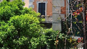 A multi-story building with a mix of architectural styles, including a balcony with a railing and a window with shutters. - Dora Flat   Amalfi centre (doorbell)