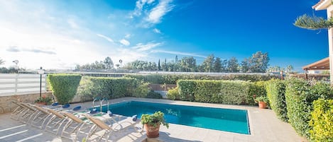A heated pool, pool loungers