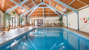 An indoor swimming pool with a wooden ceiling and seating area. - Luxury Lodge, South Devon Coast nr Plymouth, 200m to Beach + Indoor Heated Pool, (Nr Plymouth)
