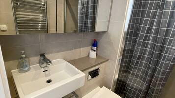 Bathtub, hair dryer, towels, soap