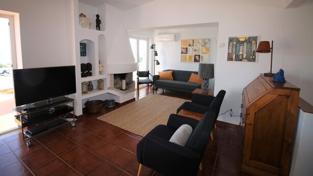 A living room with a TV, sofa, and a cabinet.