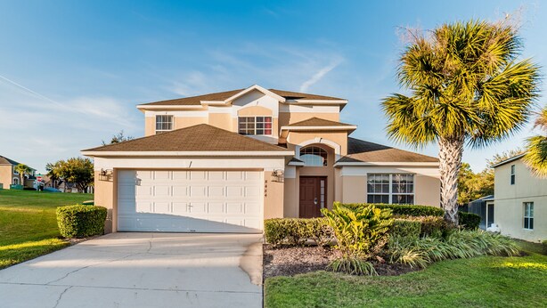 A two-story house with a garage, a front door, and a driveway. - Spacious Villa In Emerald Island Resort, Kissimmee / Orlando, Florida, USA (Kissimmee)
