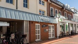 A building with a sign reading "Schmidt leander" and a number "No 22" on the facade.