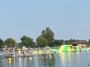 A water park with inflatable slides and a swimming area.