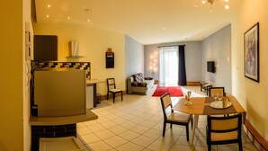 A compact living space with a kitchenette, dining area, and seating area.