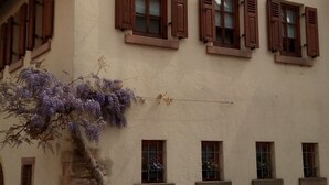 A two-story building with a sloped roof, multiple windows with shutters, and a stone base. - Holidays in the idyllic wine-growing village near Freinsheim (Bobenheim am Berg)