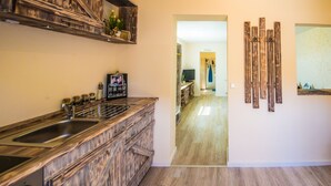 A kitchen with a wooden countertop and a built-in sink. - 30sqm vacation apartment close to the beach in the countryside (Stubbenfelde)