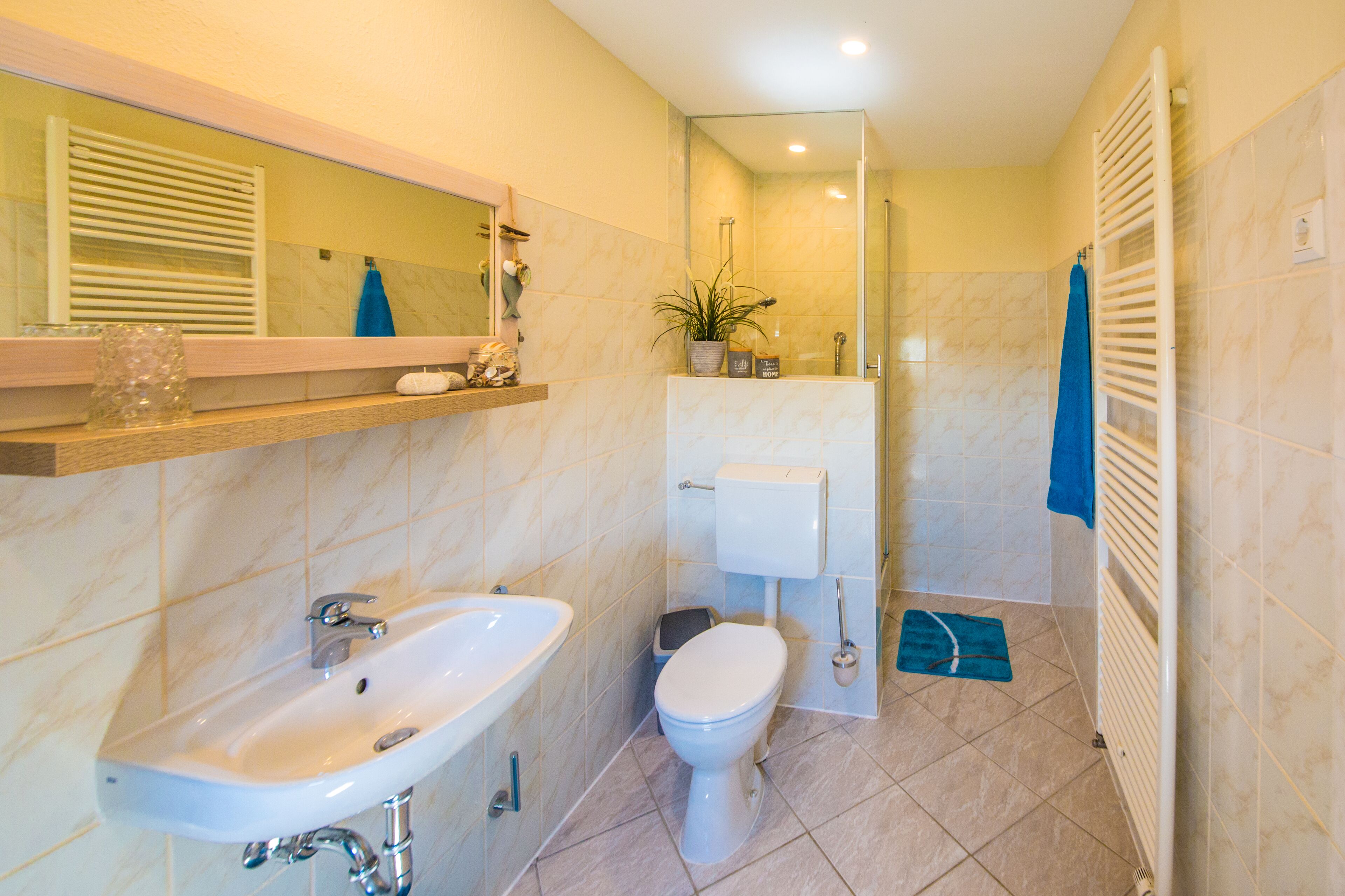 A bathroom with a sink, toilet, and shower.
