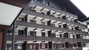 A multi-story building with balconies and large windows. - Centrally located, newly renovated non-smoking apartment with pool and sauna. (Salzburger Land)